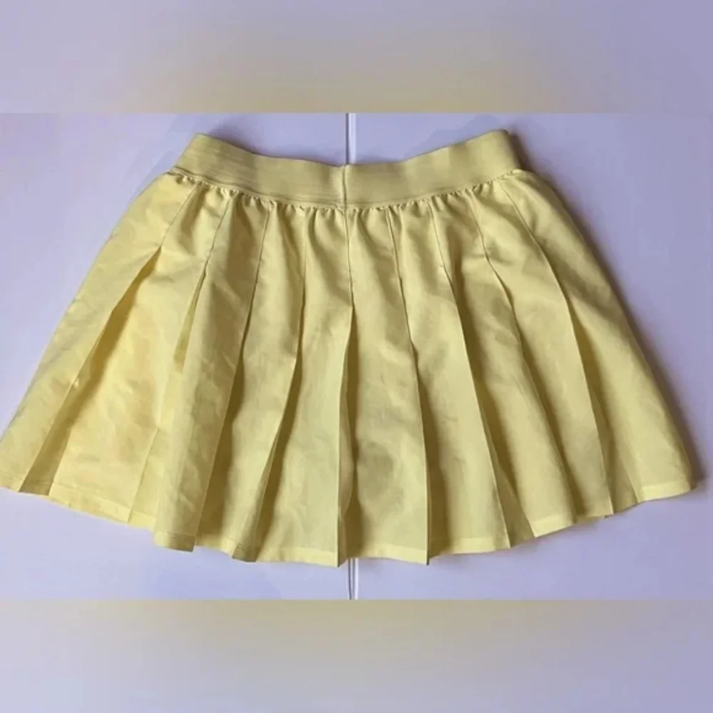 NWOT ALO YOGA Varsity Pleated Tennis Skirt Buttercup Yellow Size XXS